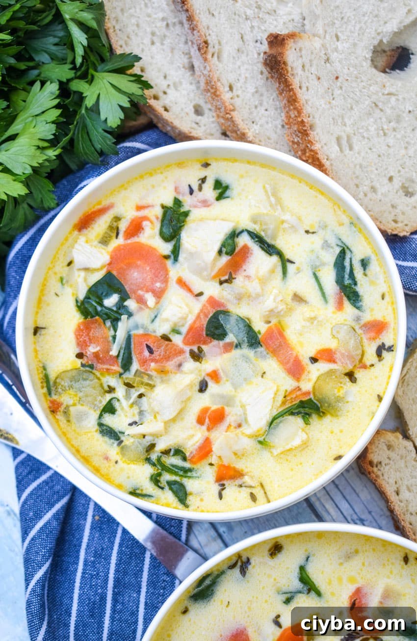 Creamy Chicken Florentine Soup with Spinach and Parmesan 4 chicken florentine soup in a white bowl with fresh herbs and slices of bread on the side
