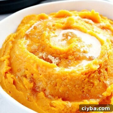 Instant Pot mashed sweet potatoes in white serving bowl.