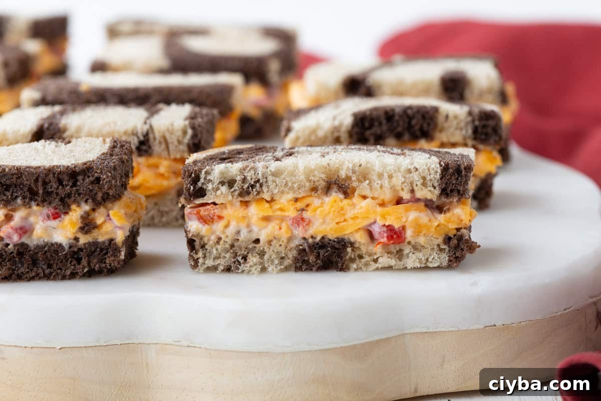 pimento cheese on marble rye, cut into finger sandwiches.