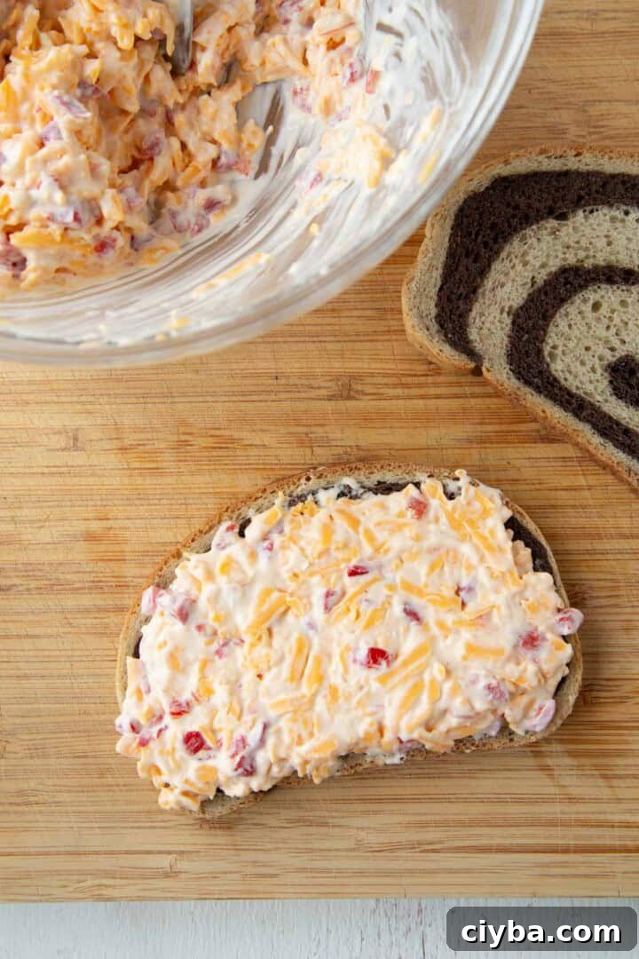 pimento cheese spread on a slice of marble rye.