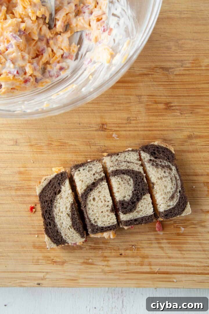 pimento cheese inside a slice of marble rye, cut into four rectangles.